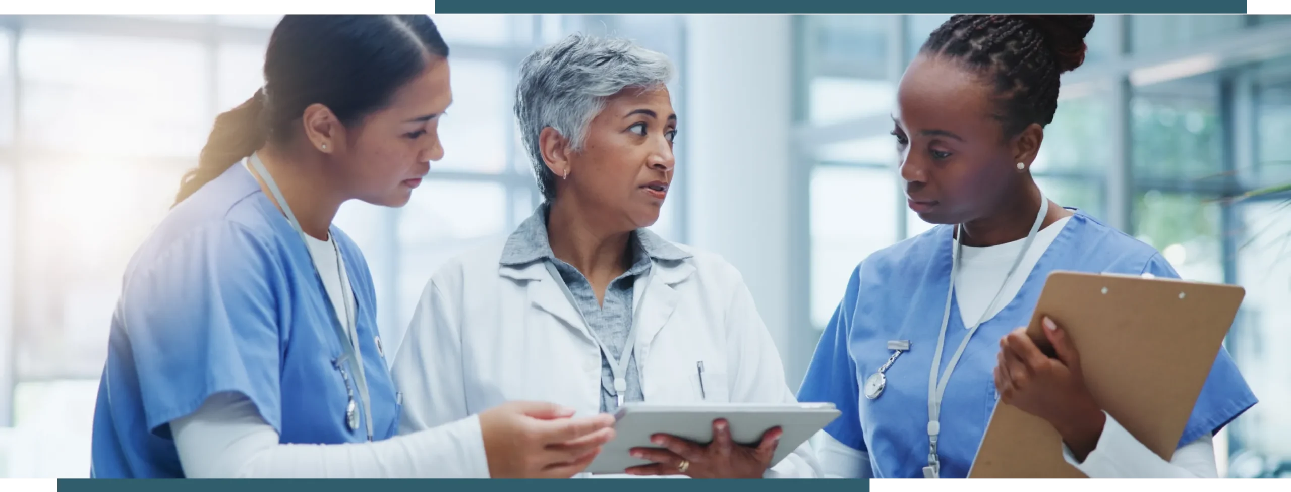 Healthcare providers reviewing patient information and collaborating on care planning in a medical facility