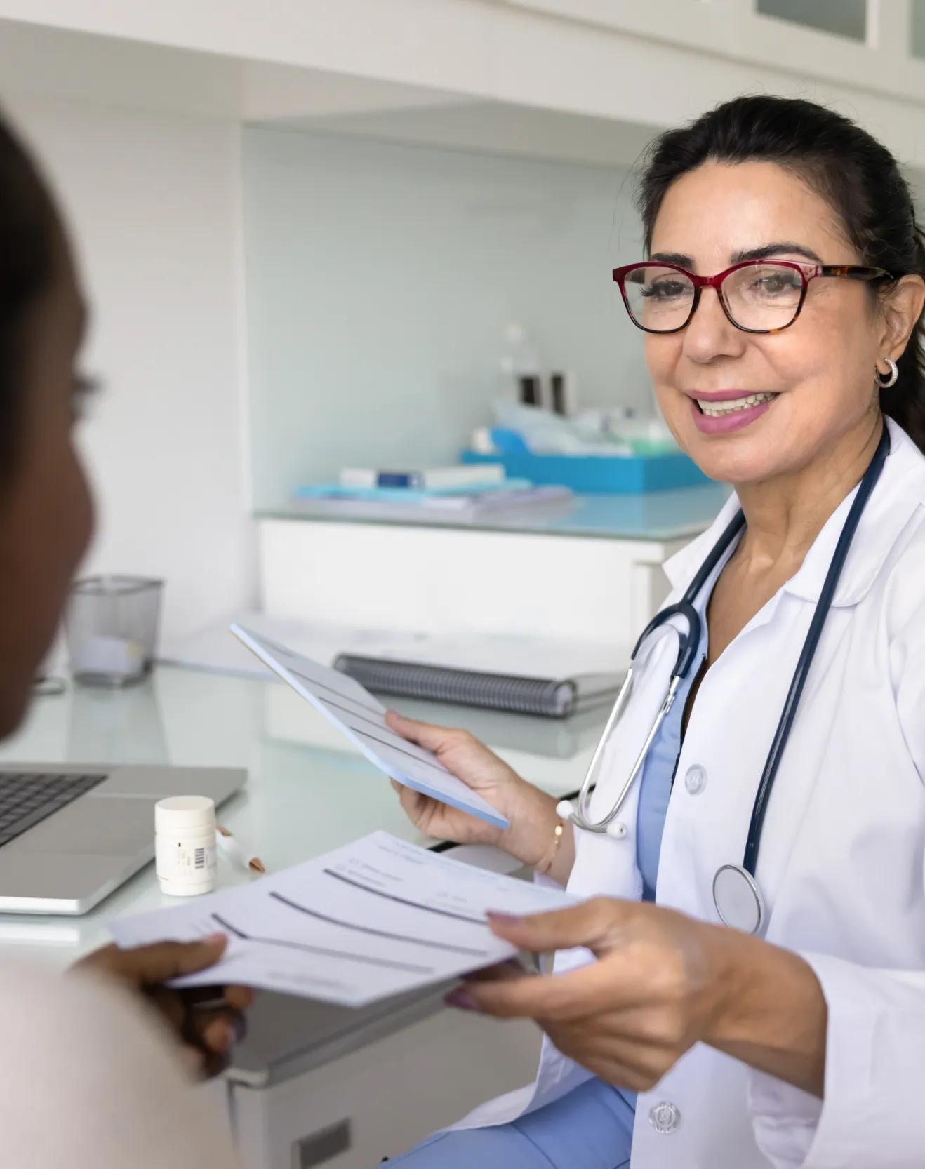 Healthcare provider reviewing referral information with a patient to improve care coordination and referral completion